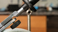 Macro view of the high-density polymer contact point between the knife jig and the support bar, reducing stick-slip during sharpening.